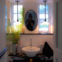 bathroom wall reflects the form of the face, with two narrow windows for eyes (lit by two pendant lights in the evening), an oval mirror for a nose, and white porcelain sink with chrome fittings for a mouth